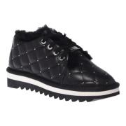 Trainers in black quilted leather with studs